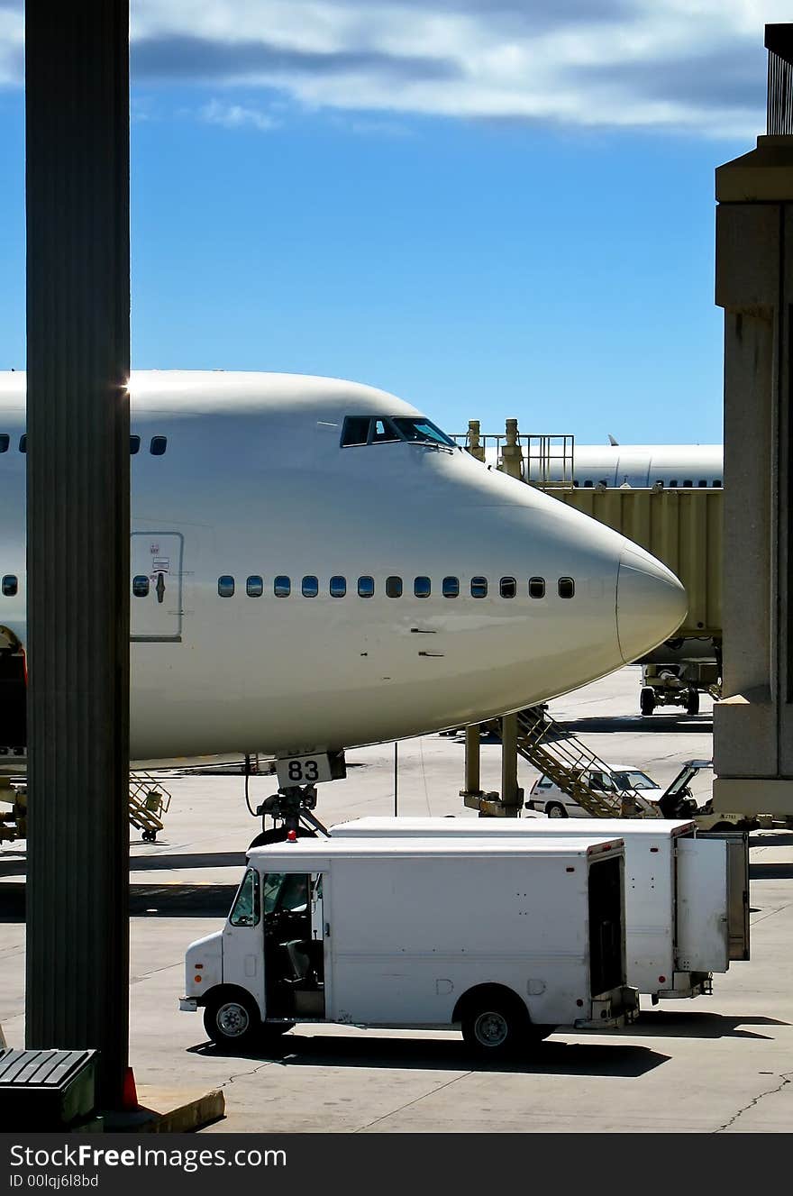 Nose of commercial jetliner parked at terminal gate. Nose of commercial jetliner parked at terminal gate