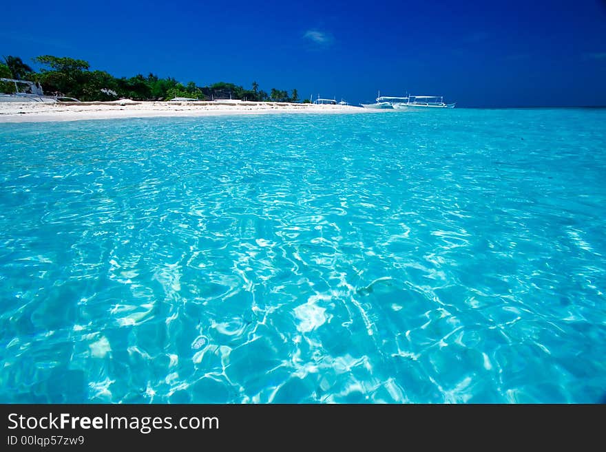 Ocean View of beautiful pacific blue water beside a tropical island with white sand. Ocean View of beautiful pacific blue water beside a tropical island with white sand