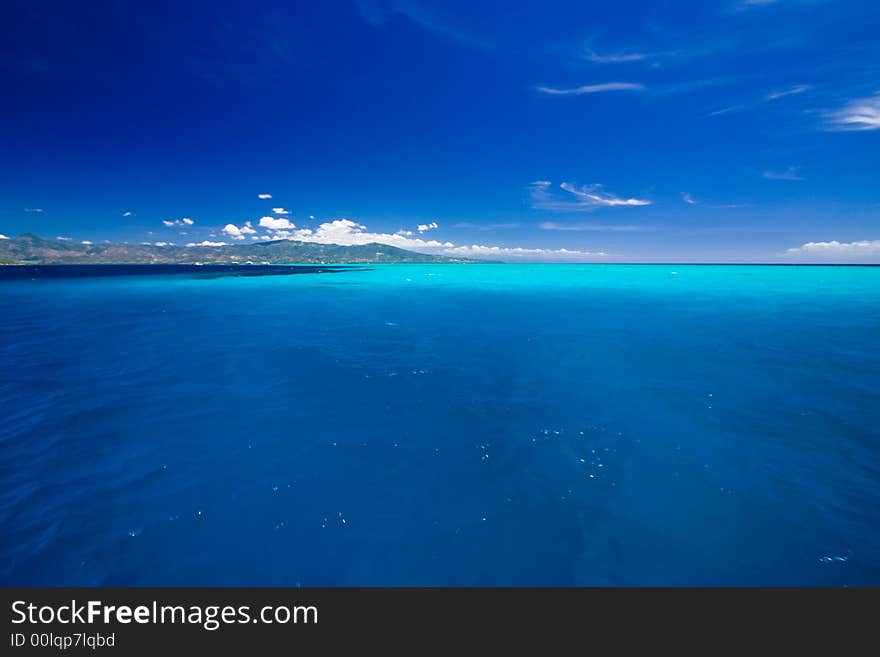 Ocean view of beautiful caribbean blue water beside a secluded white sand beach. Ocean view of beautiful caribbean blue water beside a secluded white sand beach