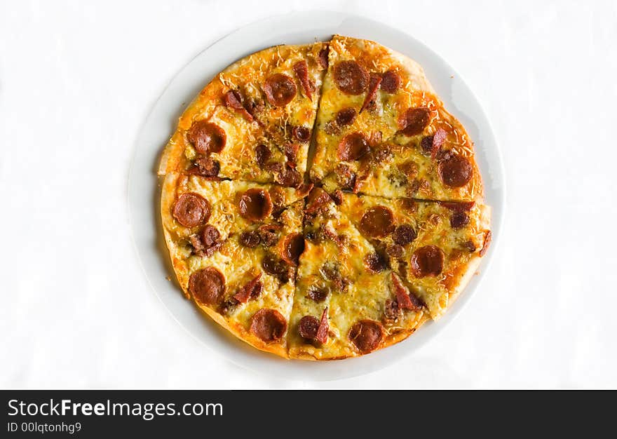 Detail shot of hot fresh pepperoni pizza isolated against a white background with great colors and depth of field. Room for text. Detail shot of hot fresh pepperoni pizza isolated against a white background with great colors and depth of field. Room for text.