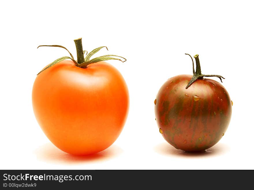 Close up of a red round tomato and a plum-like tomato on white background. Close up of a red round tomato and a plum-like tomato on white background