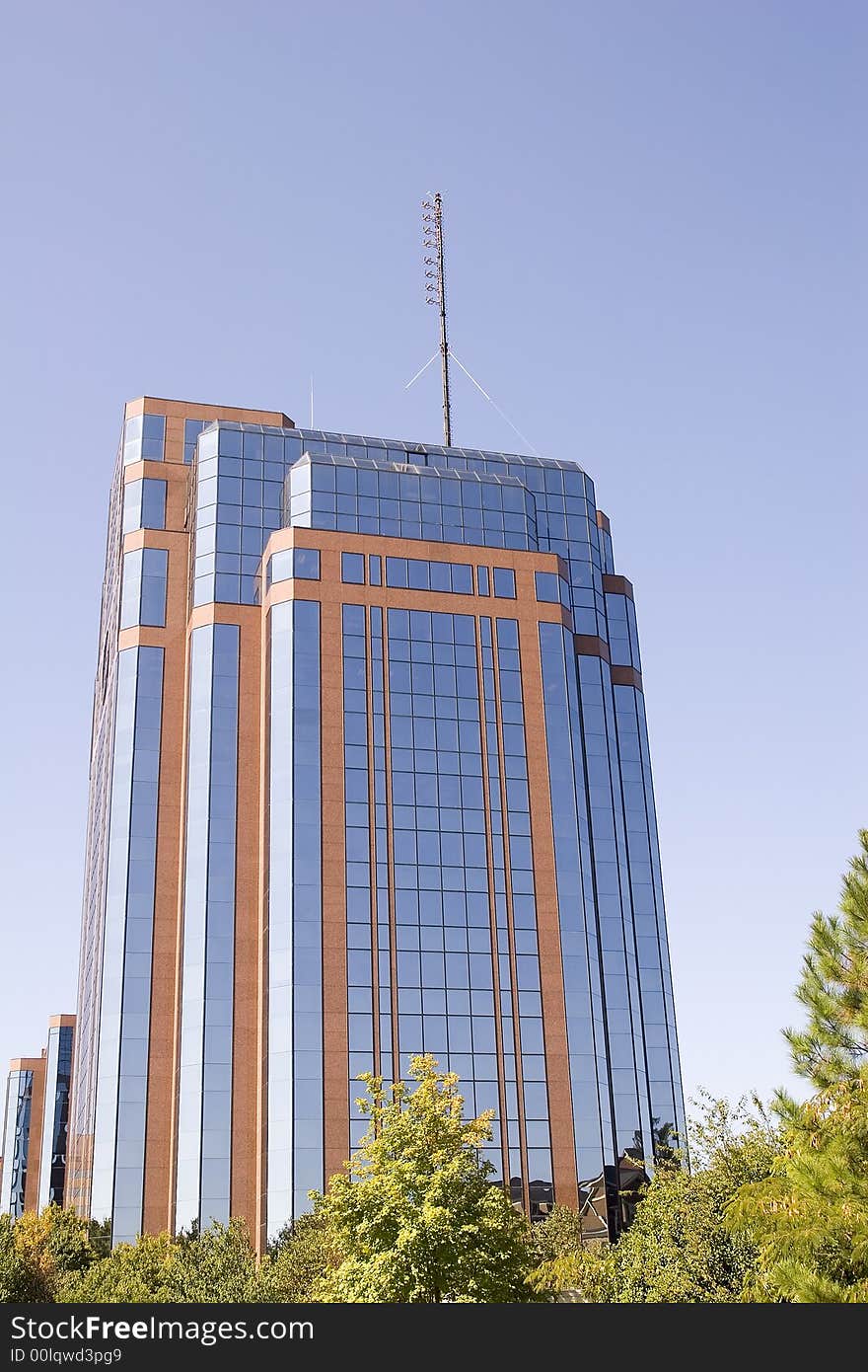 A modern brick and glass office building against blue sky. A modern brick and glass office building against blue sky