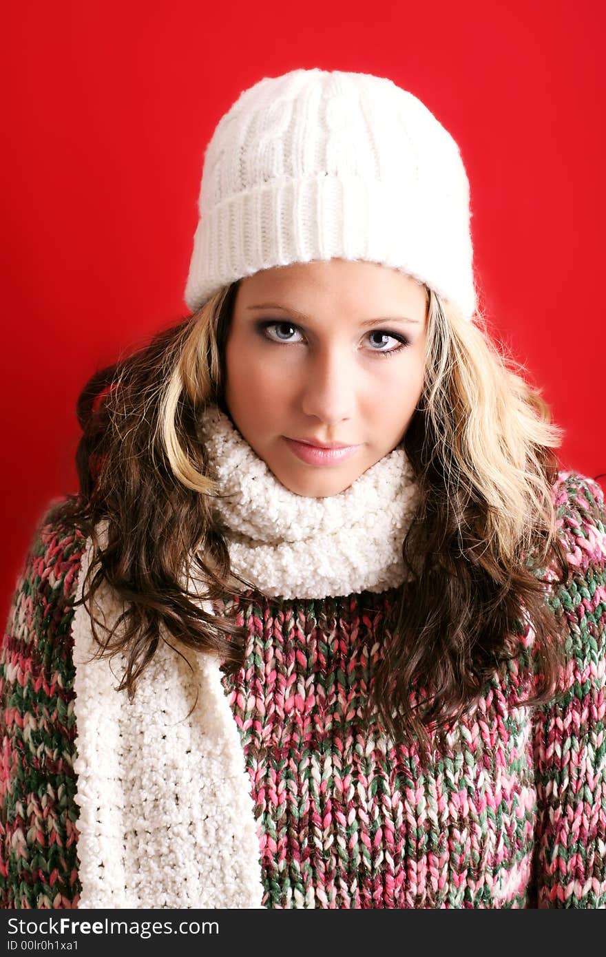 Winter portrait of a beautiful young woman with a cap and a scarf. Winter portrait of a beautiful young woman with a cap and a scarf