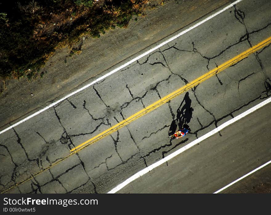 Bicycle racer with silhouette on old highway. Bicycle racer with silhouette on old highway