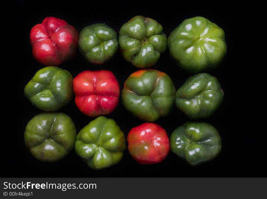 Red and green  bellpeppers composition over black