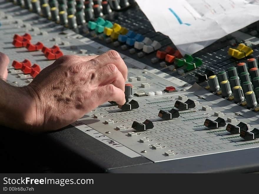 Hand of an sound or music mixer in action