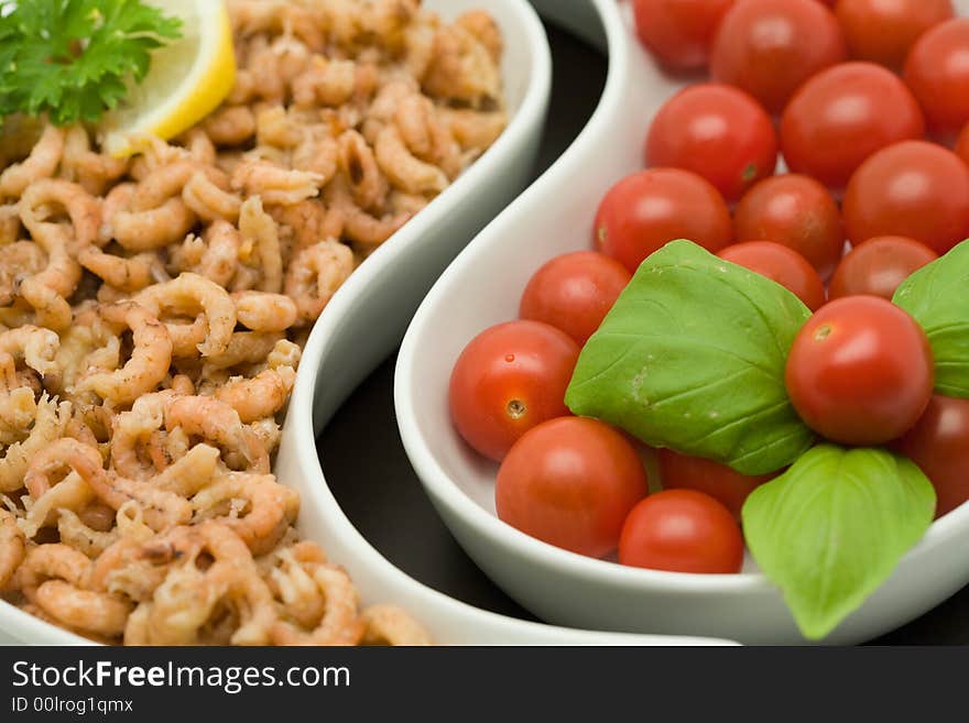 Shrimp and tomato appetizers decorated with persil, basil and a slice of lemon