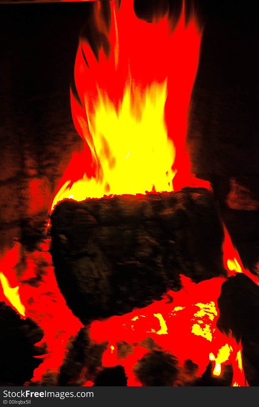 Blazing log in domestic fireplace. Blazing log in domestic fireplace