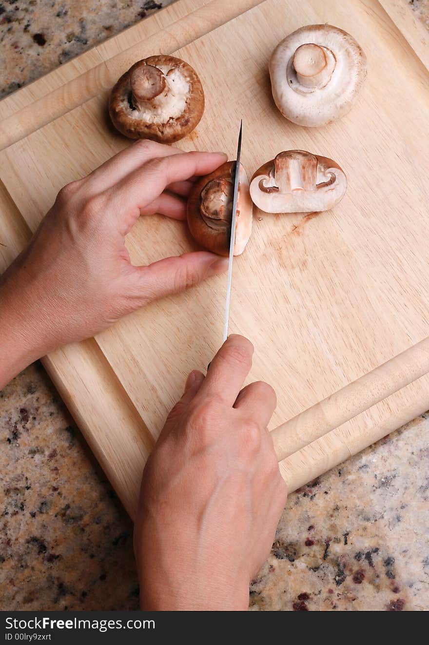 Wooden cutting board slicing mashrooms. Wooden cutting board slicing mashrooms.