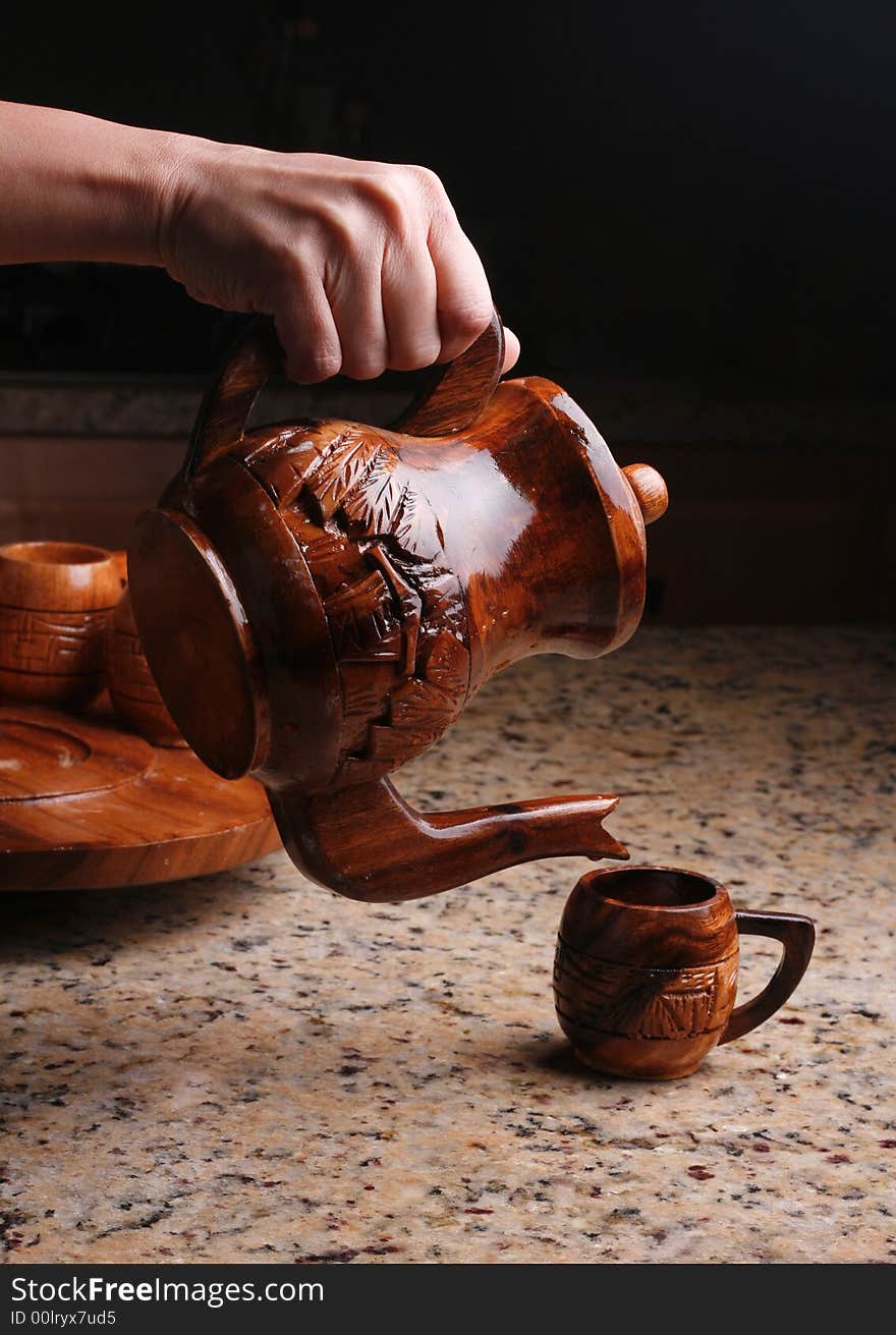 Pouring wooden tea cup or coffee cup. Pouring wooden tea cup or coffee cup