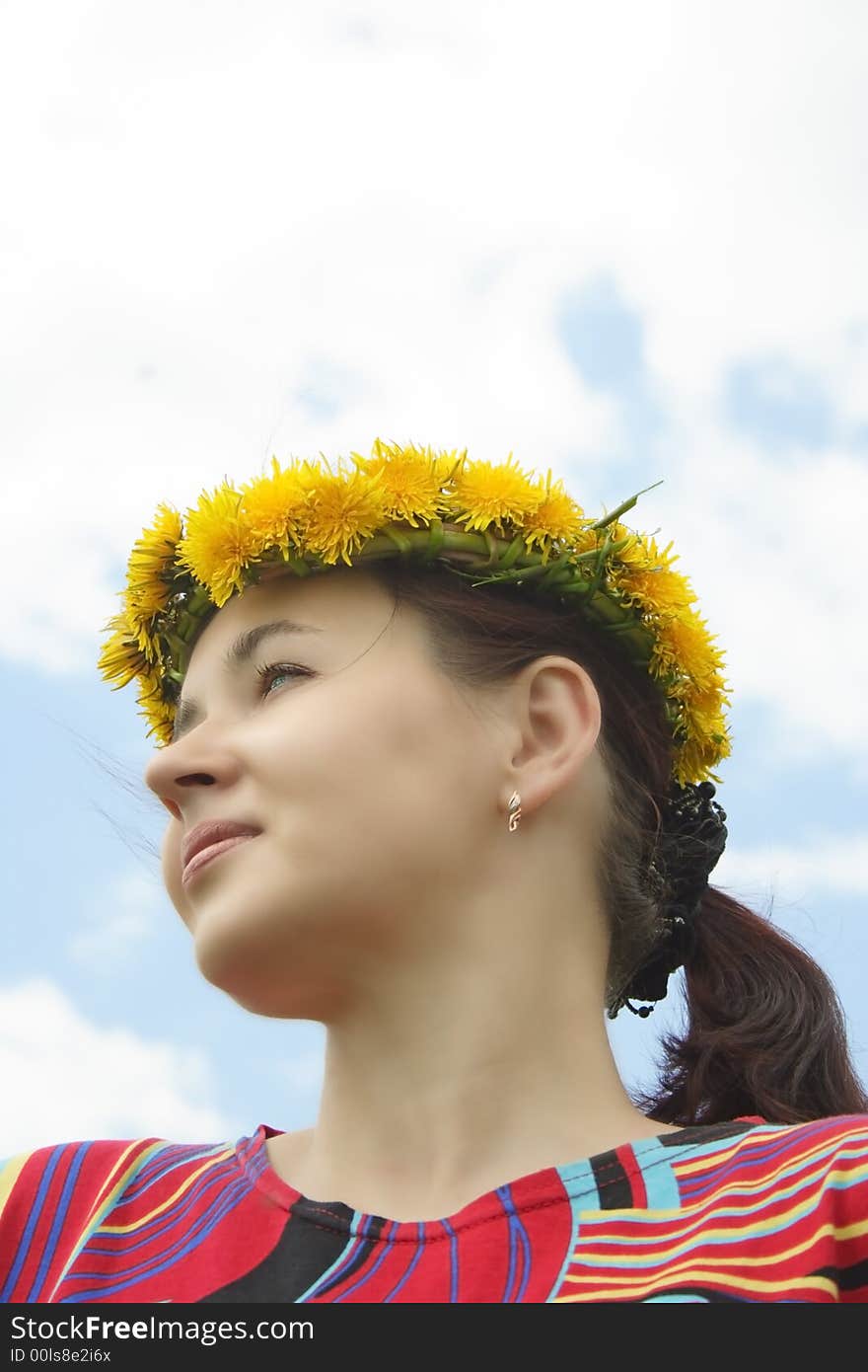 Happy woman with diadem of wild flowers