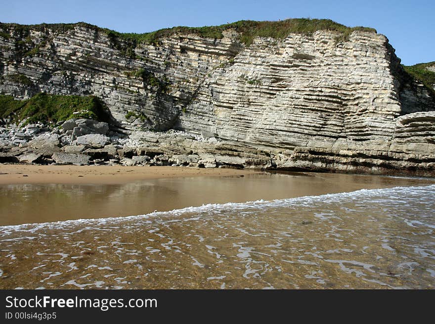 A monumental rock surrounded by the sea. A monumental rock surrounded by the sea