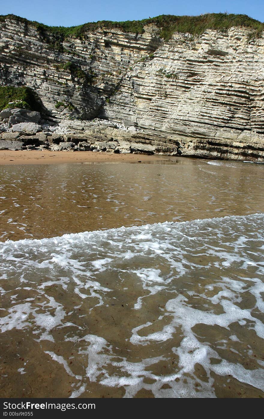 A monumental rock surrounded by the sea. A monumental rock surrounded by the sea