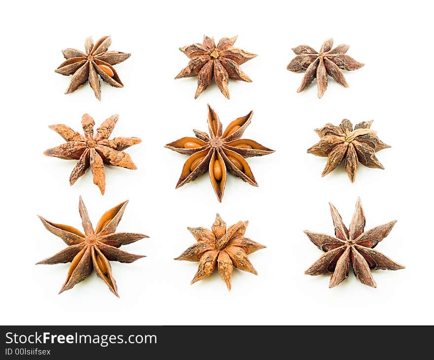 Arrangement of nine star anise in three rows alternating between top and bottom view. Arrangement of nine star anise in three rows alternating between top and bottom view.