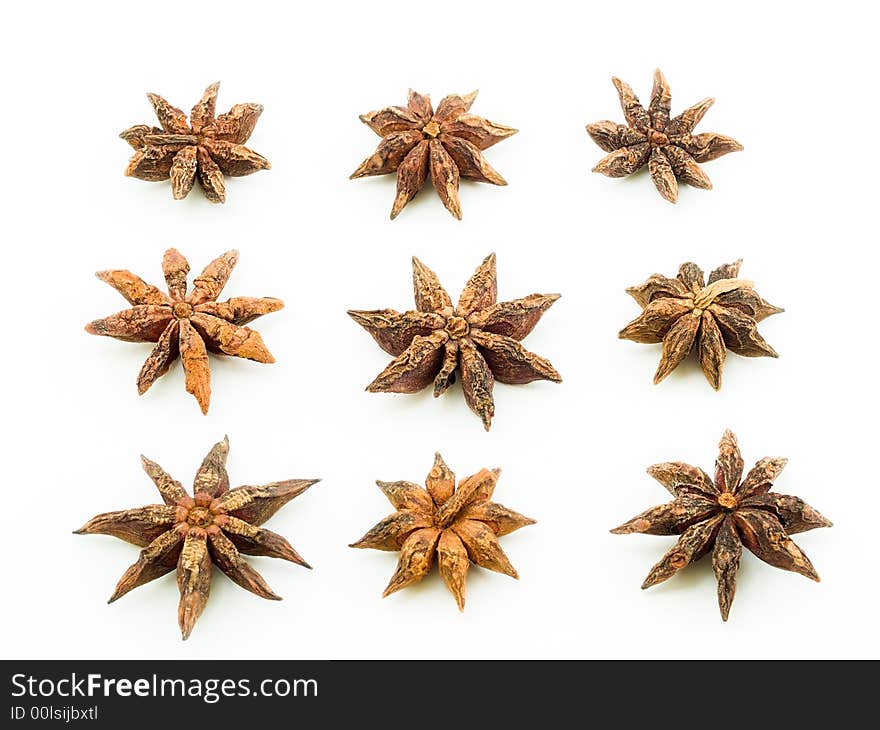 Arrangement of nine star anise in three rows with each star showing the top view. Arrangement of nine star anise in three rows with each star showing the top view