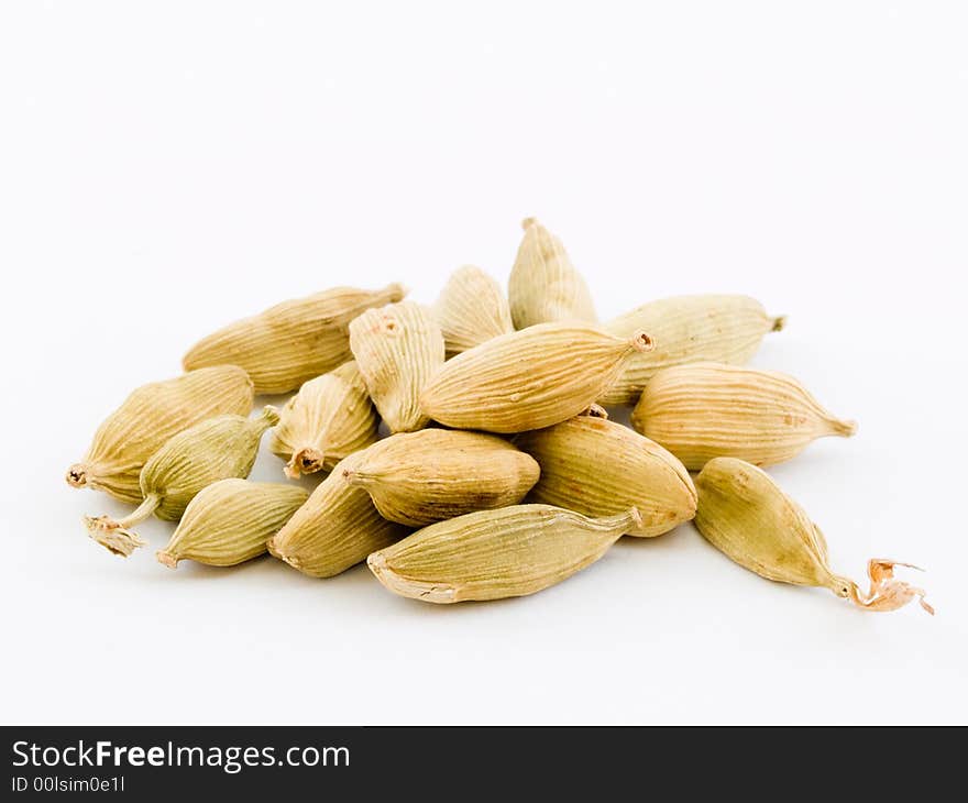 Still life of a pile of cardamom isolated on white background