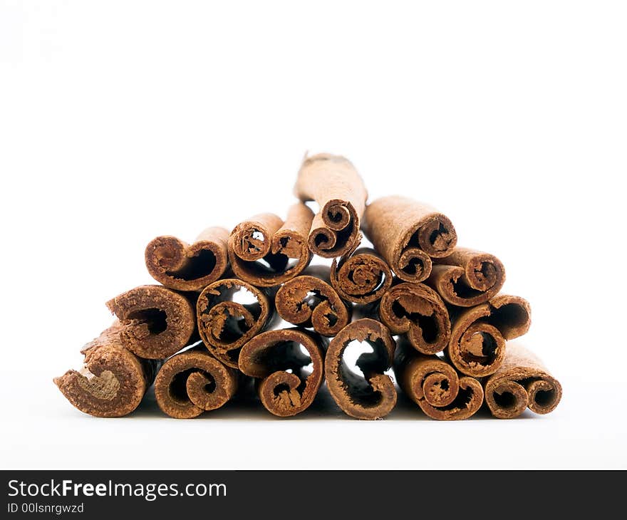 End-wise perspective of a pile of cinnamon sticks isolated on white background. End-wise perspective of a pile of cinnamon sticks isolated on white background.