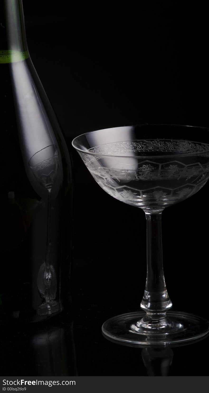 Champagne Botlte with a glass on a black background. Champagne Botlte with a glass on a black background