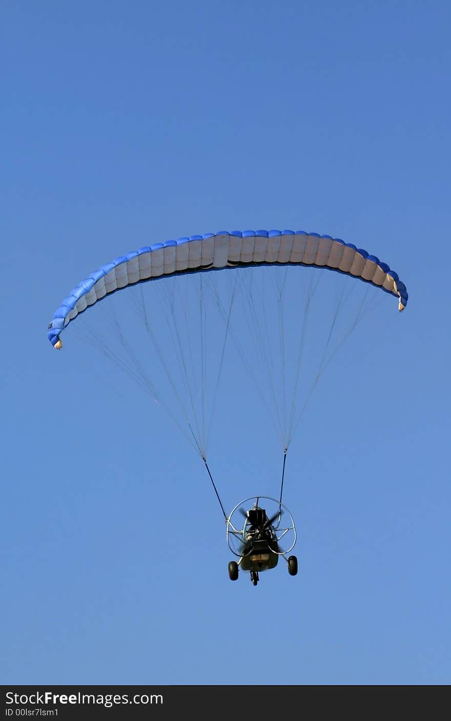 Motor powered glider ion blue sky background