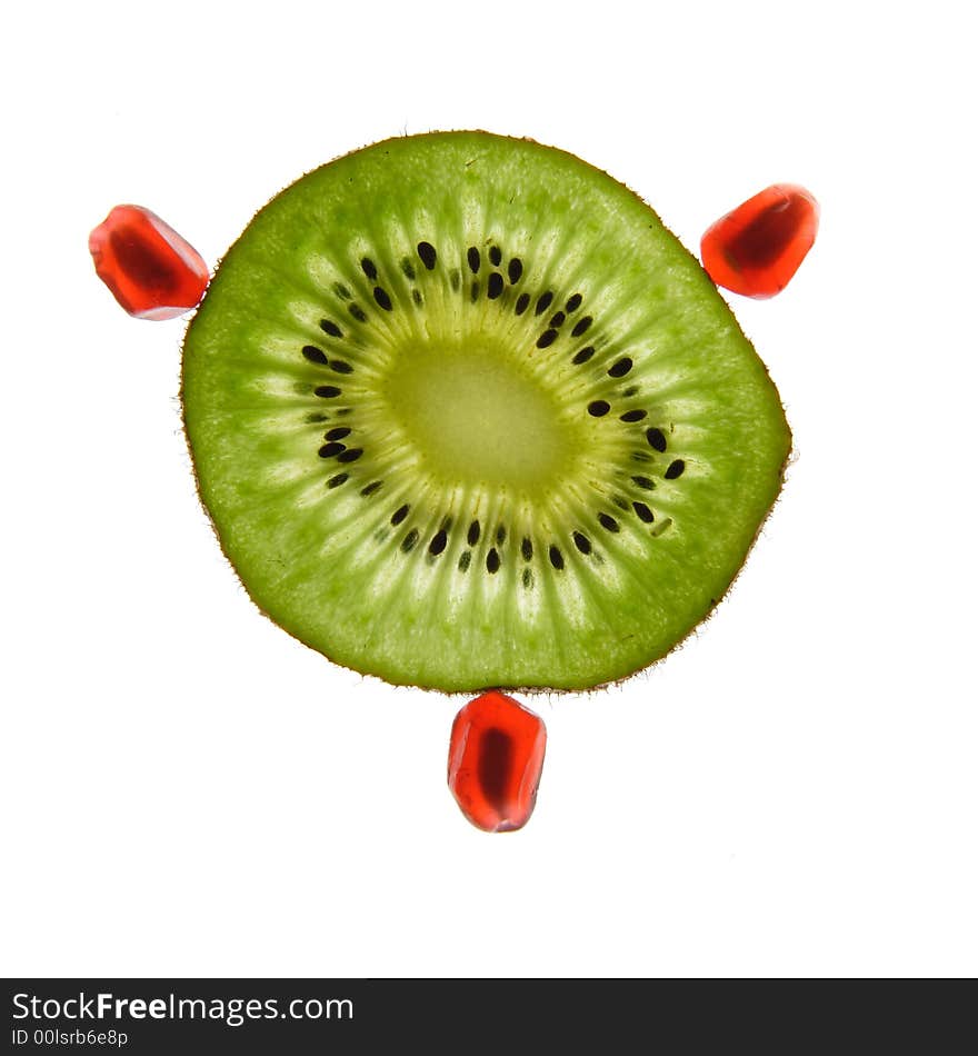 One kiwi and pomegranate on a white background