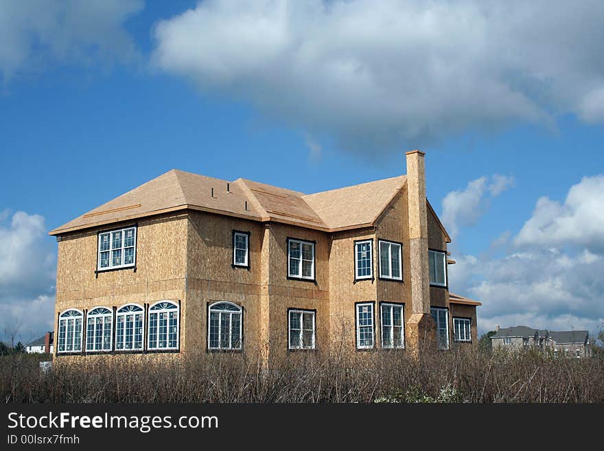 A New House being constructed under a blue sky. A New House being constructed under a blue sky