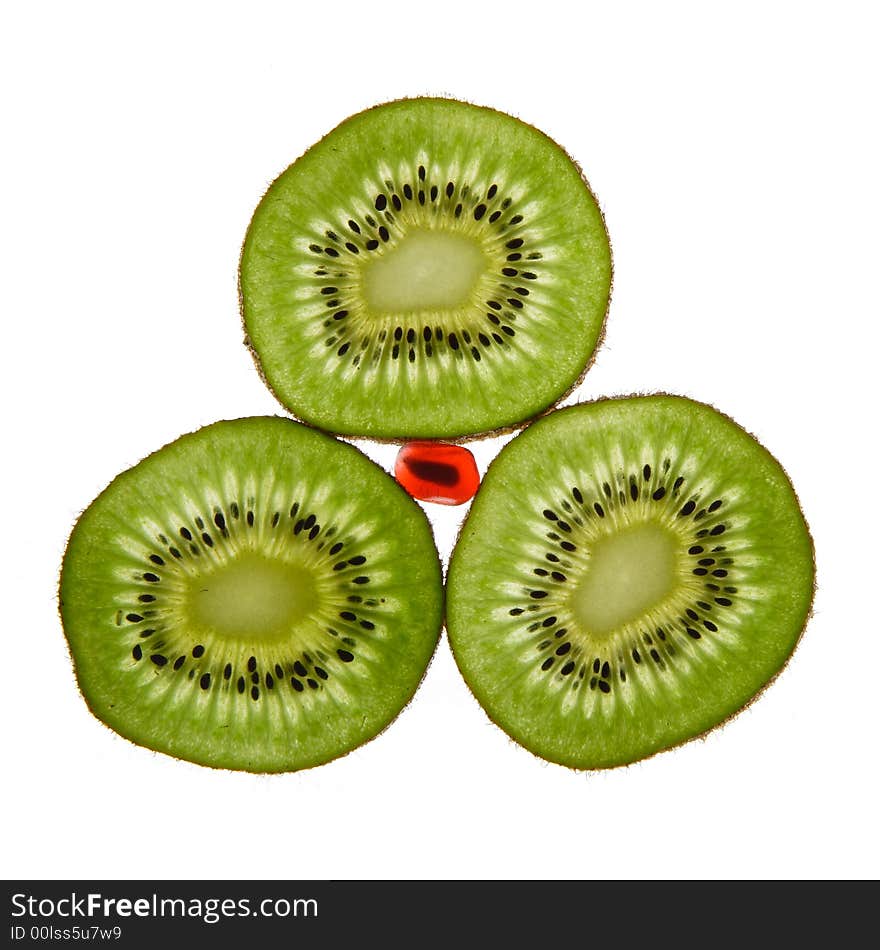 Three kiwis and pomegranate on a white background