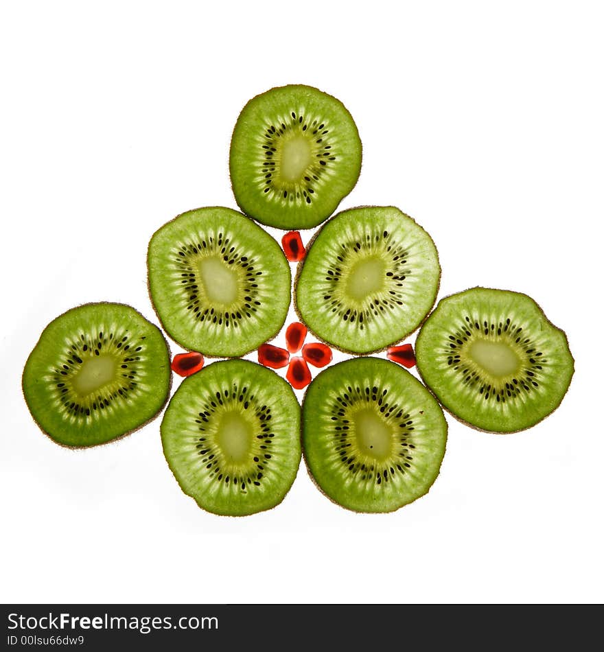 Seven kiwis and pomegranate on a white background