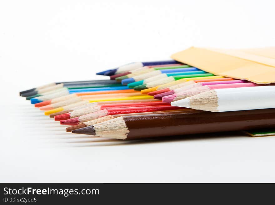 Colored wooden crayons/pencils in a box. Colored wooden crayons/pencils in a box.