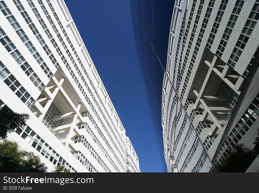 Upward view of City Hall and reflection in the glass exterior of a theater. The Hague, Holland.