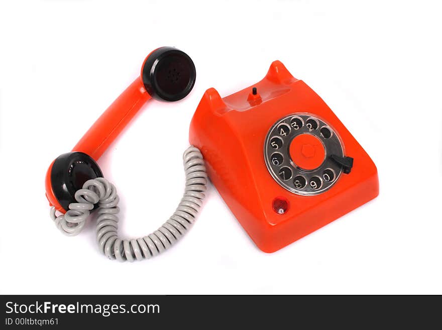 Orange plastic phone on the white background