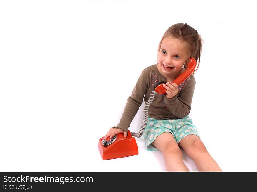 Portrait of very nice young girl with old phone on the white background