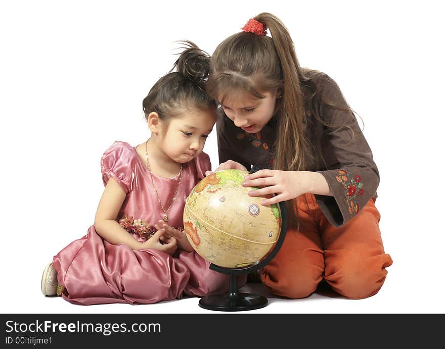 Two girls with long hair slavonic and asiatic appearance consider globe. Isolated. Two girls with long hair slavonic and asiatic appearance consider globe. Isolated