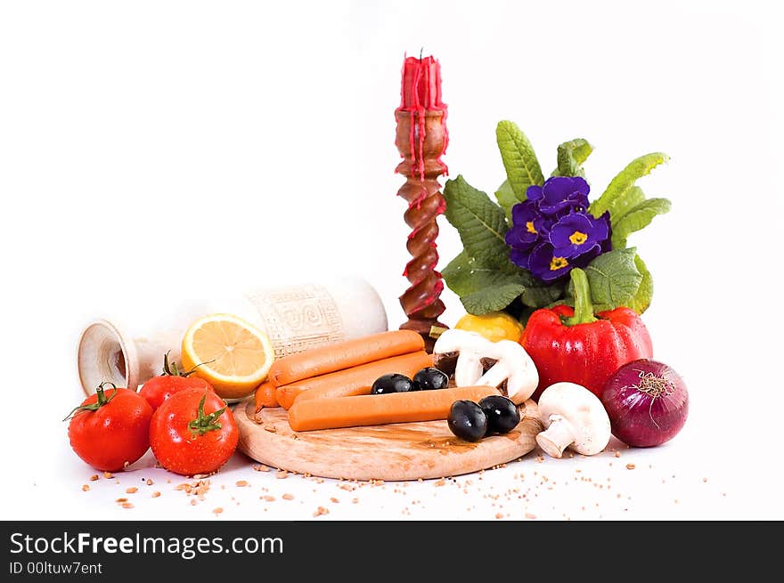 Hot-dogs and vegetables on a cutting board