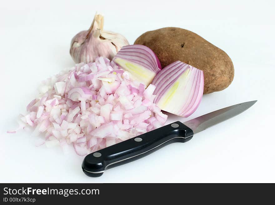 Red onions sliced and diced, garlic and potato for cooking. Red onions sliced and diced, garlic and potato for cooking