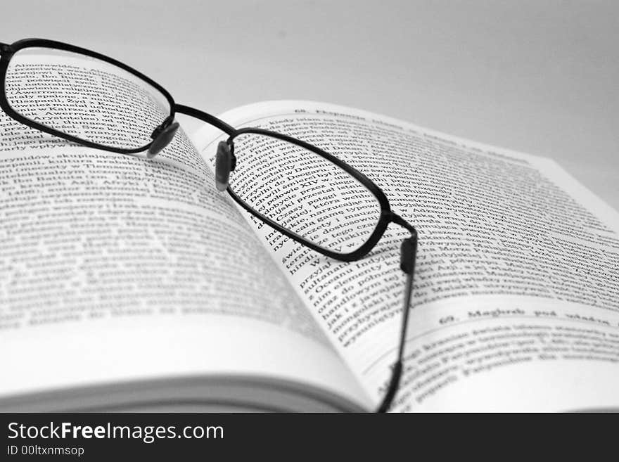 History book with glasses in black and white. History book with glasses in black and white.