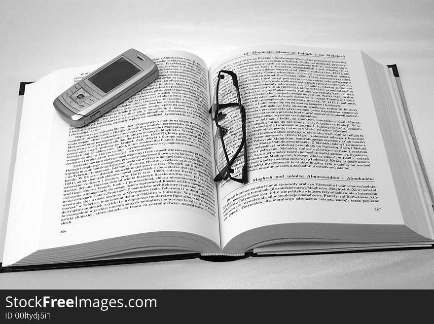 History book with glasses and mobile phone. History book with glasses and mobile phone.