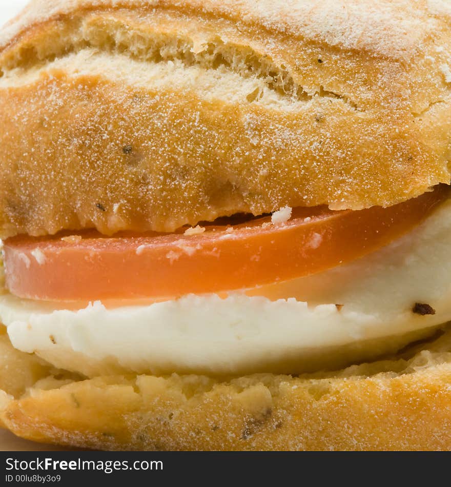 Close-up of a gourmet sandwich with cheese and tomato