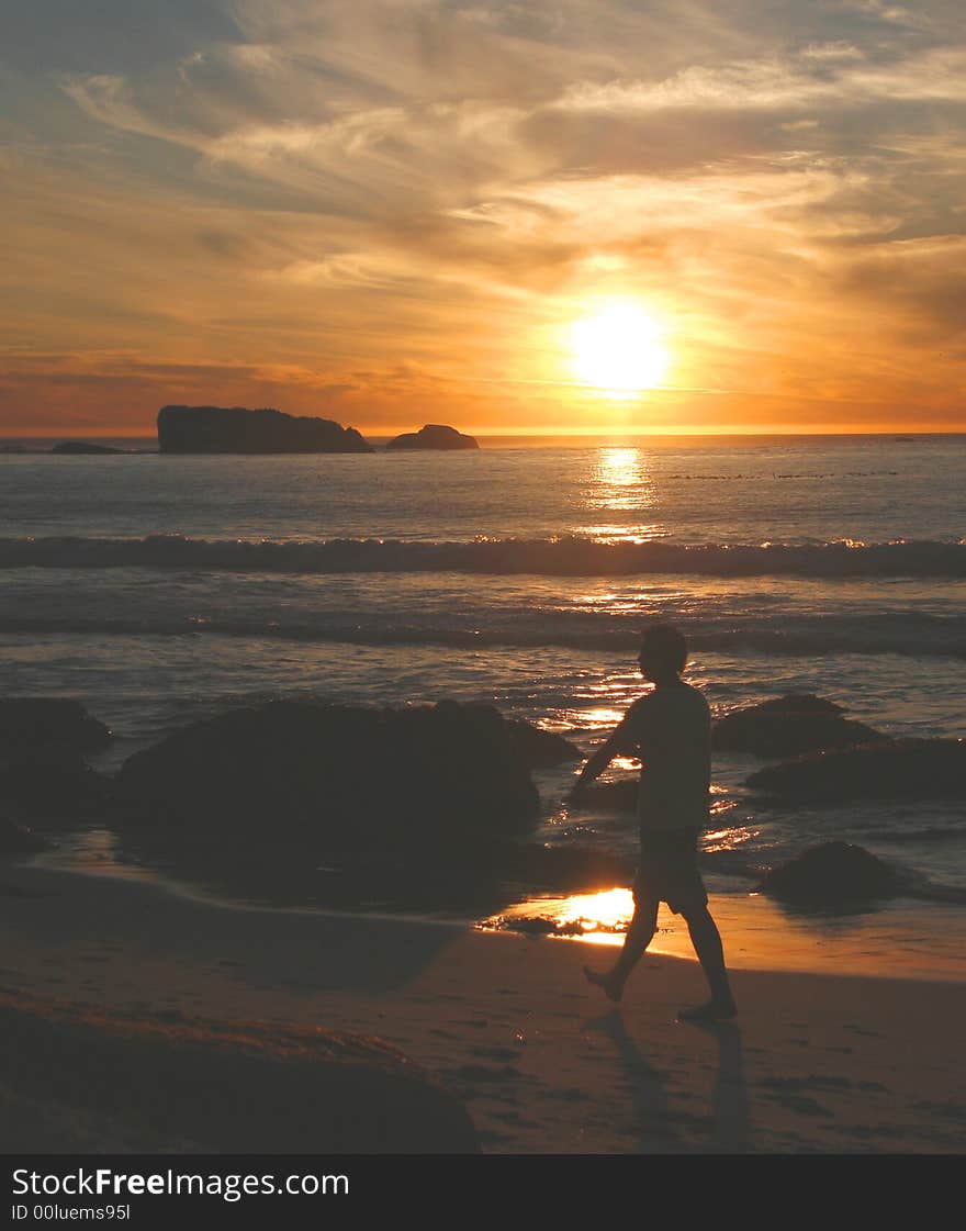 Stunning sunset on Clifton 2nd beach, Cape Town with silhout ette of man walking along beach. Stunning sunset on Clifton 2nd beach, Cape Town with silhout ette of man walking along beach.