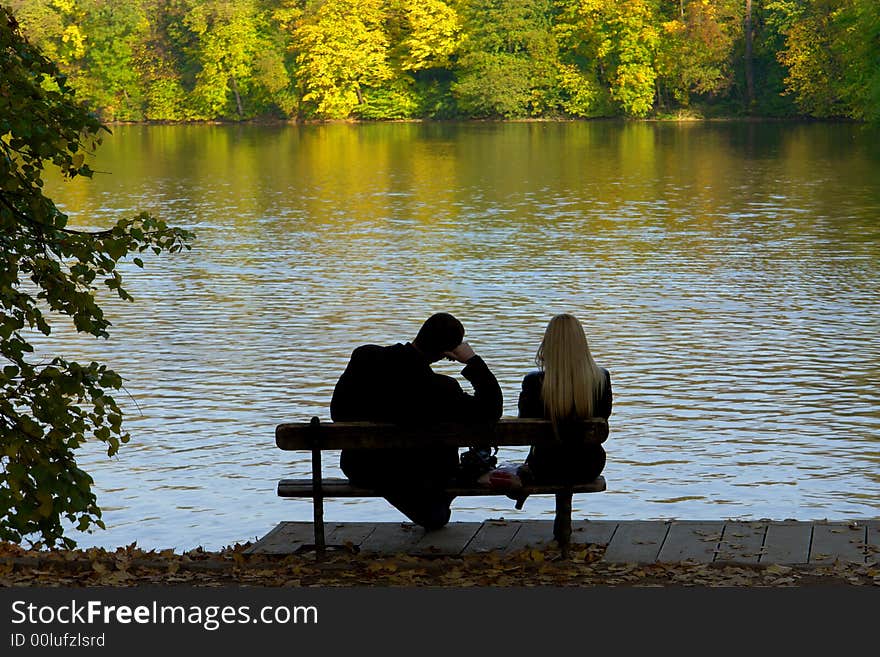 Man and the woman on a background of lake. Man and the woman on a background of lake