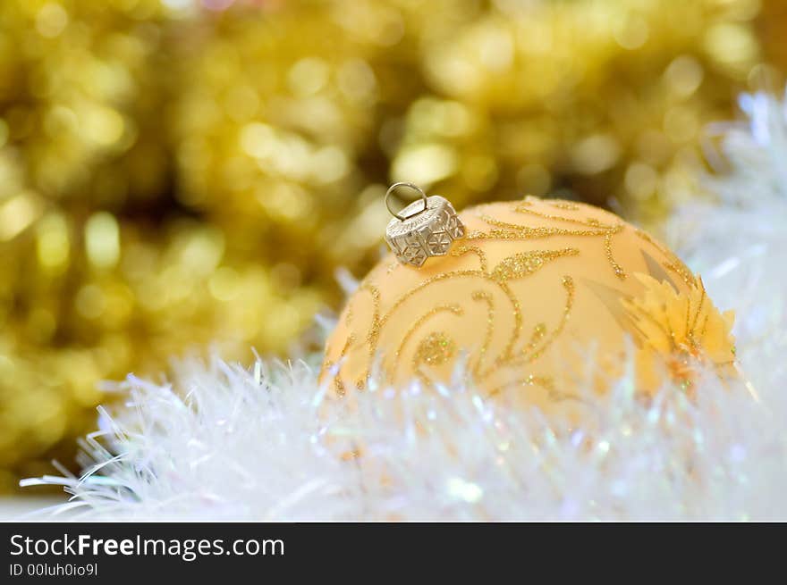 Golden christmas ball on abstract background