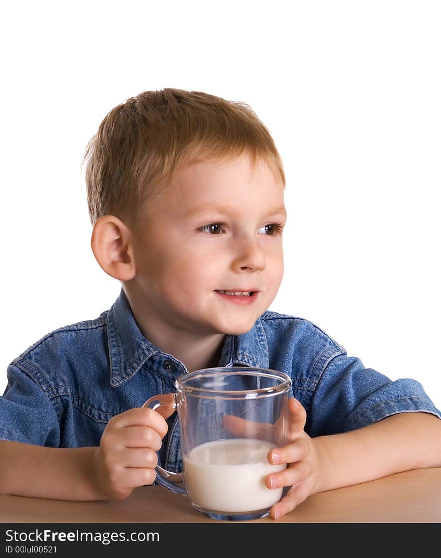 The child drinks milk from a mug