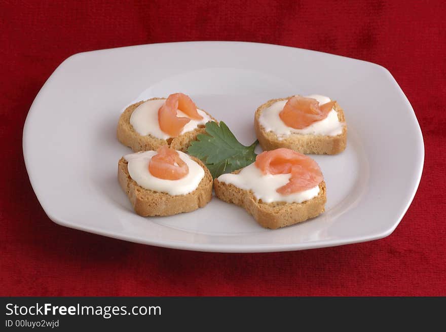 Four snacks in white plate