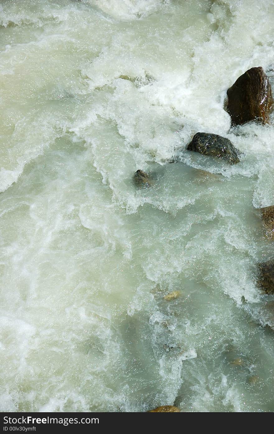 River rapid shot taken with fast shutter speed; vertical orientation. River rapid shot taken with fast shutter speed; vertical orientation