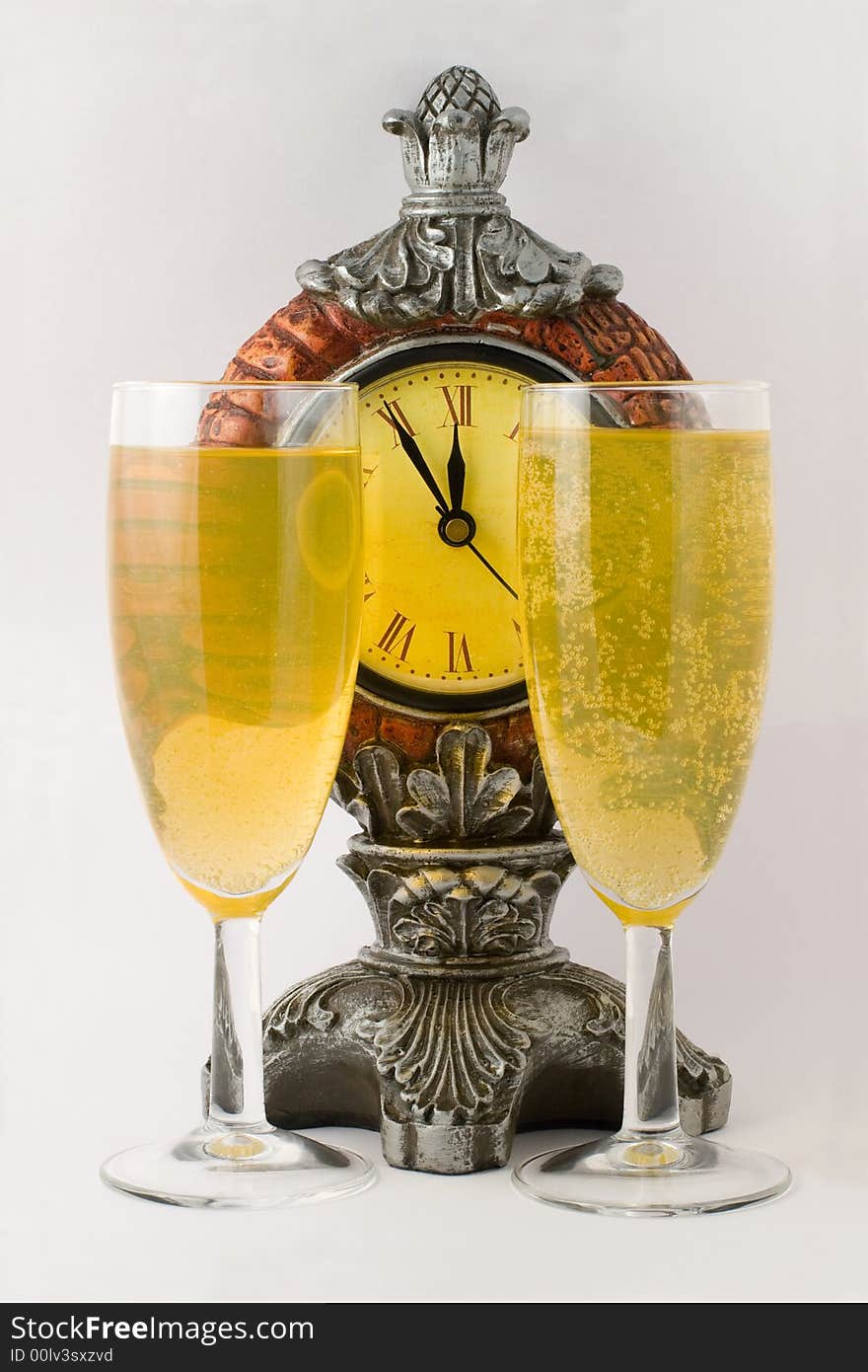 Clock and two tall wine glass