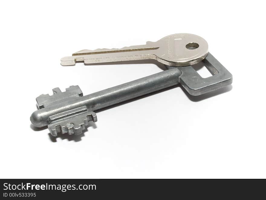 Metal keys from an entrance door of an apartment. The image is isolated.