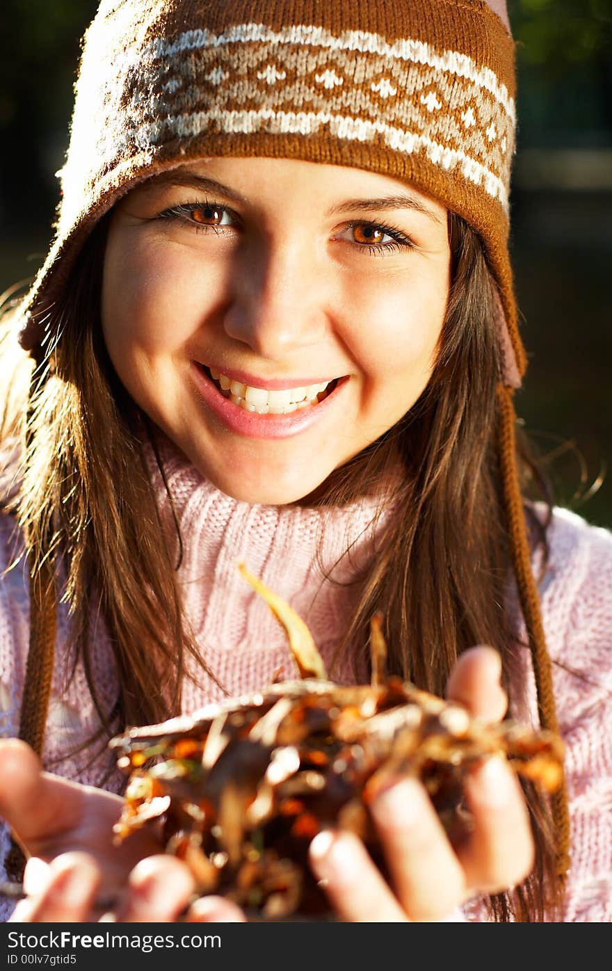 Beautiful young girl with golden leaves in her hands - great smile. Beautiful young girl with golden leaves in her hands - great smile