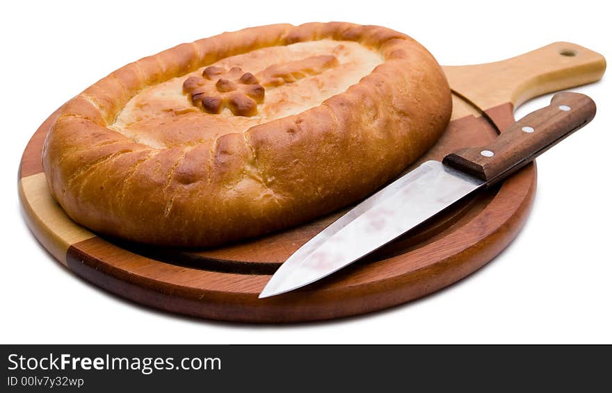 Celebratory pie on a chopping board with a knife. Celebratory pie on a chopping board with a knife.