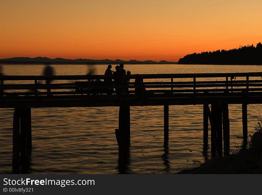 The sun sets over the pier at whiterock beach bc canada. The sun sets over the pier at whiterock beach bc canada