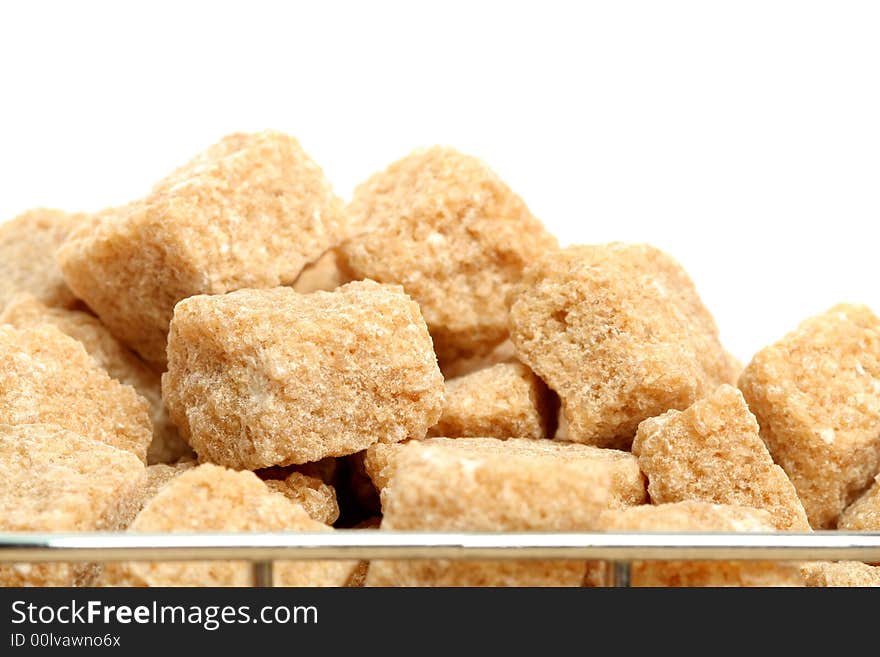 Stack of not refined brown reed sugar, on white. Stack of not refined brown reed sugar, on white