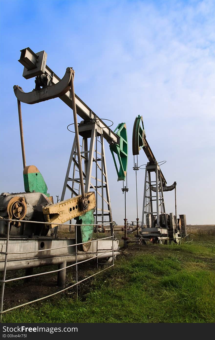 Old oilwells on the landscape. Industrial background